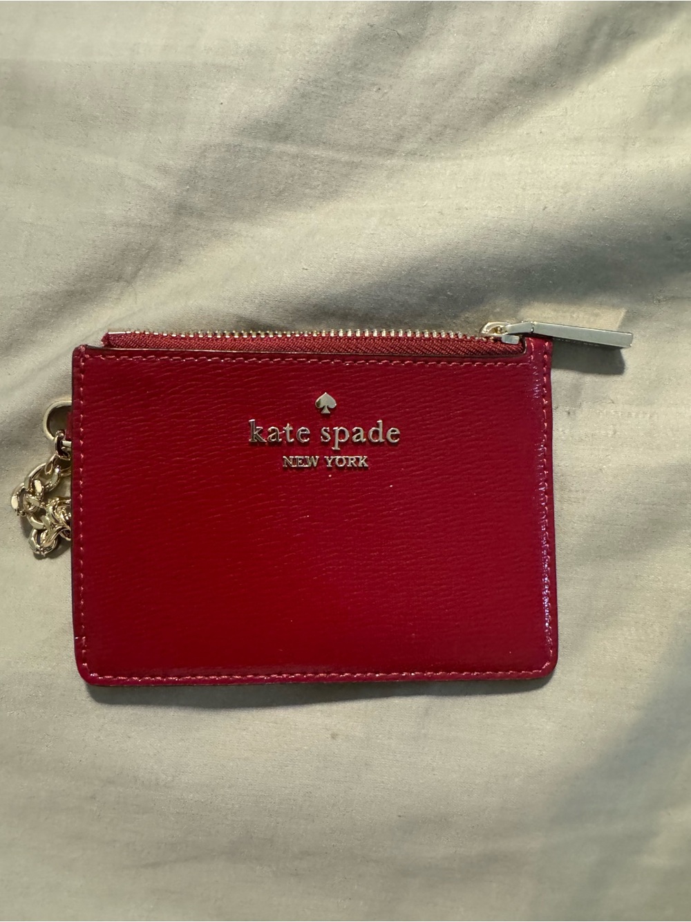 kate spade red leather zip card pouch with gold logo